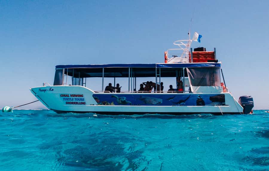 Coral Bay Glass-Bottom Boat Tour - Boarding from the beach and settling on Nhanya-Ku