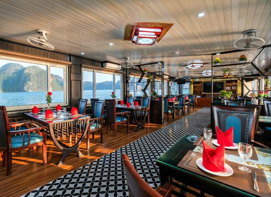 Halong Bay: Day Cruise with Caves, Kayaking & Sunset Party - Lunch with Dog Rock and Fighting Cock Islet outside the window