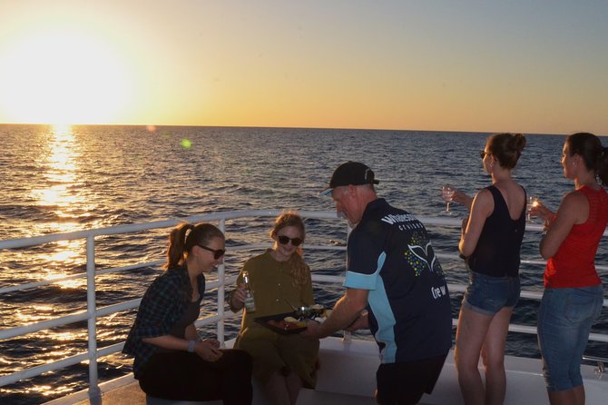 Hervey Bay Sunset Cruise - Outdoor decks, indoor seating, and rainy weather